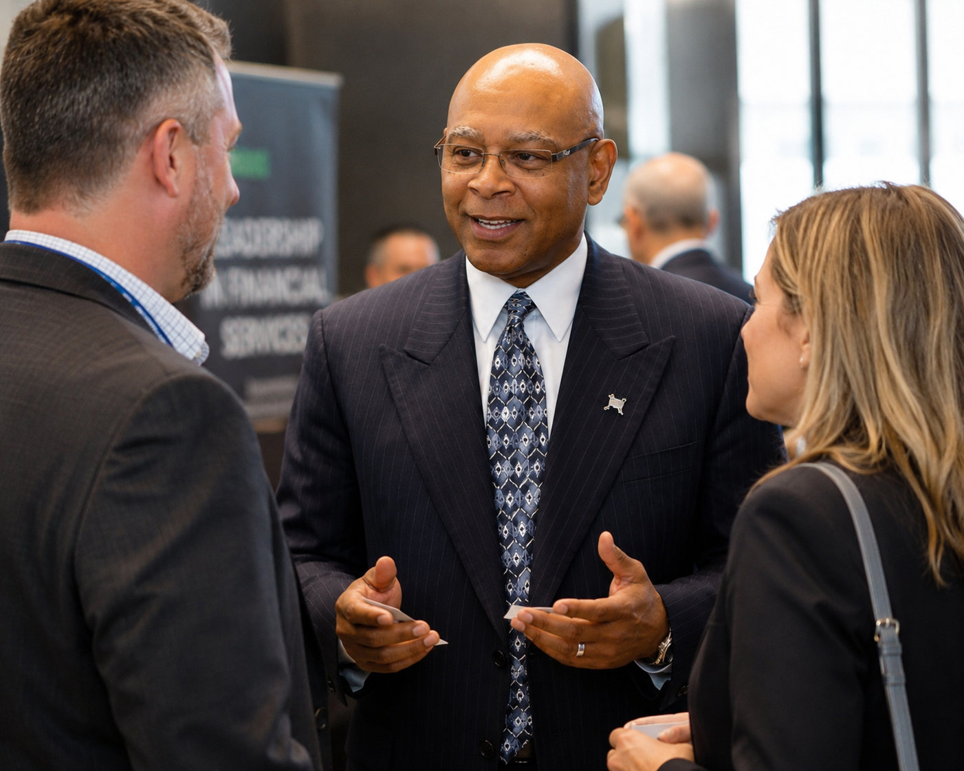 Fred Perry speaking with clients at a financial leadership event